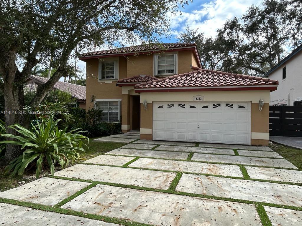 Marbella Park Hialeah, FL 33015 - Photo 2 of 24 a view of a house with a door and tree in the background