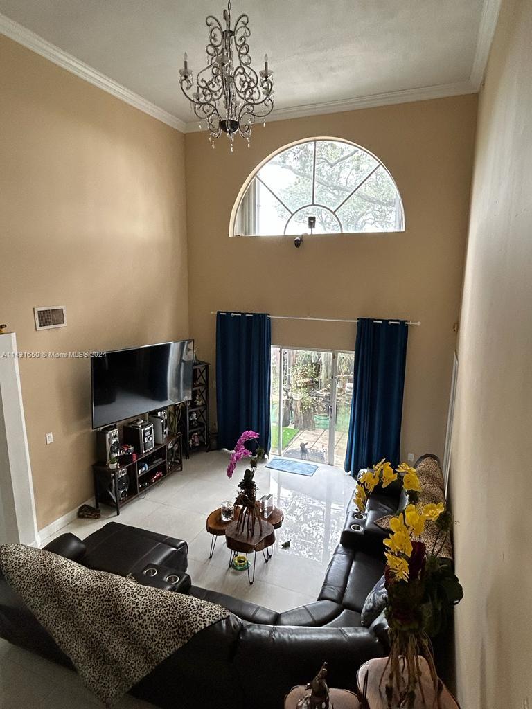 Marbella Park Hialeah, FL 33015 - Photo 10 of 24 a room with furniture and a flat screen tv