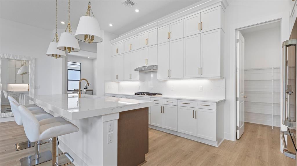 1520 Southeast Savoy Way Stuart, FL 34997 - Photo 11 of 39 a kitchen with stainless steel appliances granite countertop a sink stove and refrigerator