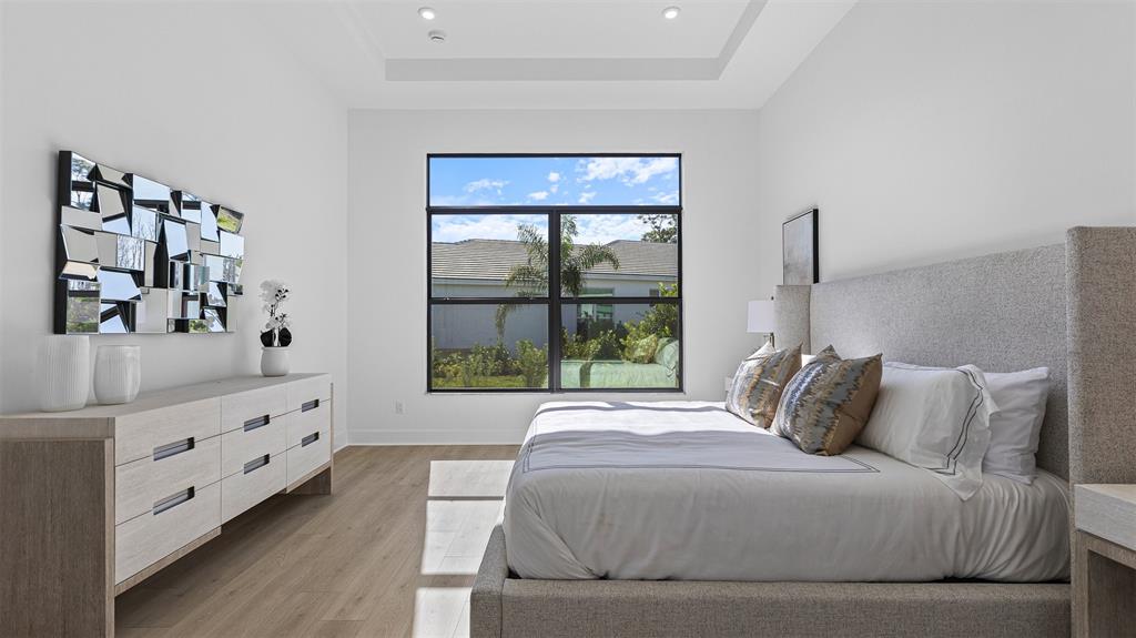 1520 Southeast Savoy Way Stuart, FL 34997 - Photo 16 of 39 a bedroom with a bed and a window