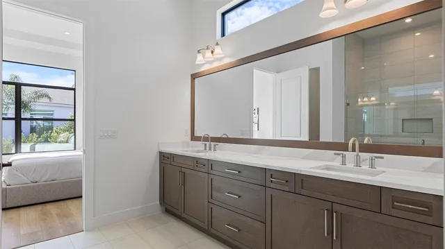 a bathroom with a double vanity sink and a mirror