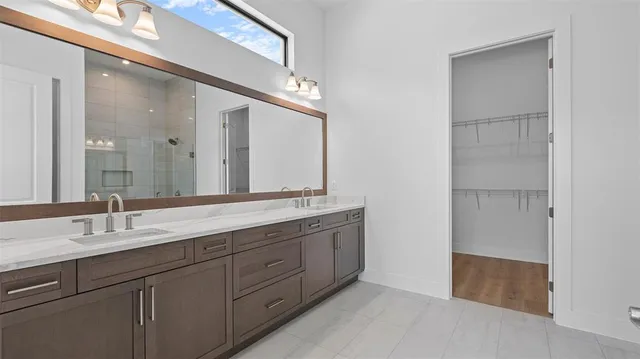 a bathroom with a double vanity sink and a mirror