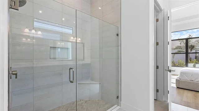a bathroom with a glass shower door