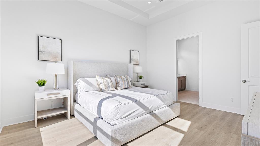 1520 Southeast Savoy Way Stuart, FL 34997 - Photo 22 of 37 a bedroom with a bed and a potted plant