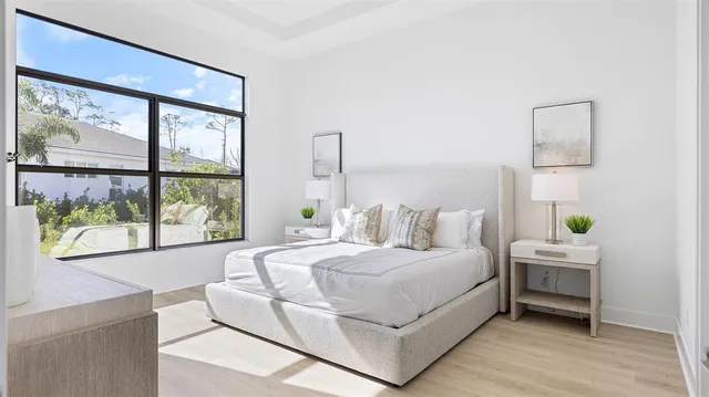 a bedroom with a bed and a window