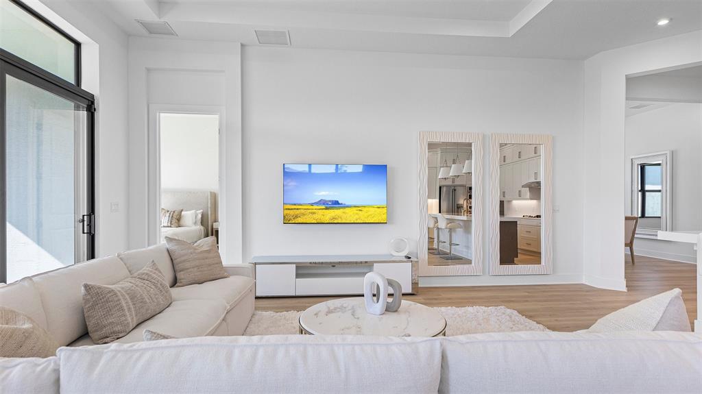 1520 Southeast Savoy Way Stuart, FL 34997 - Photo 8 of 39 a living room with furniture and a flat screen tv