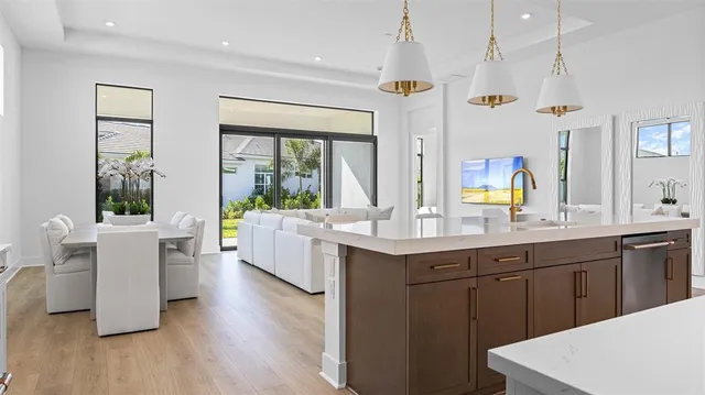 a large kitchen with kitchen island a white cabinets and sink