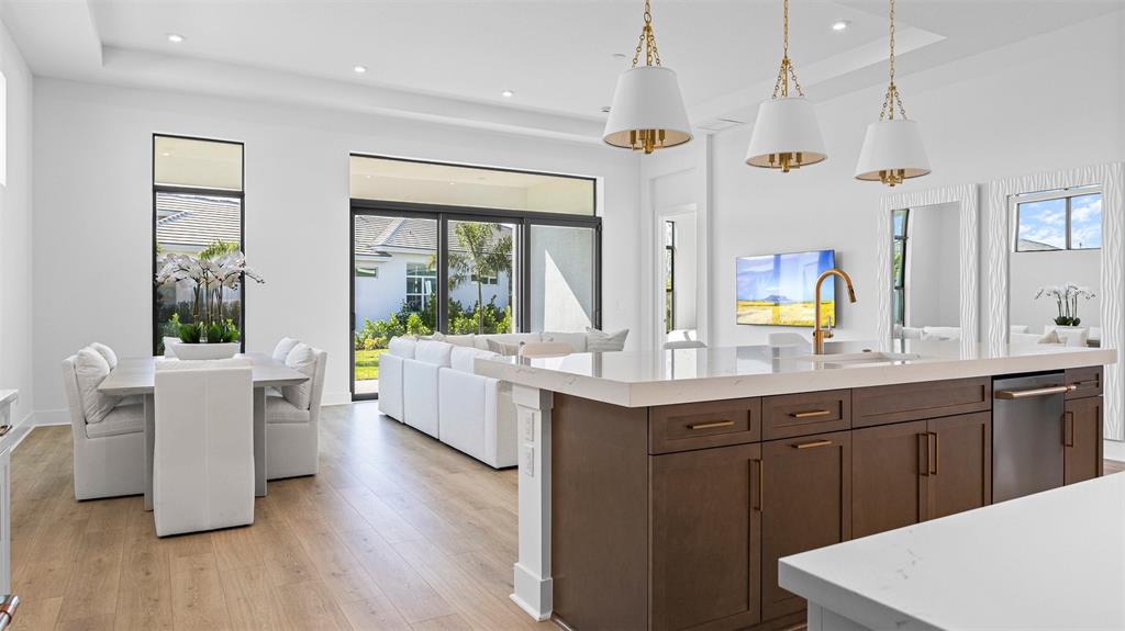 1520 Southeast Savoy Way Stuart, FL 34997 - Photo 9 of 39 a large kitchen with kitchen island a white cabinets and sink