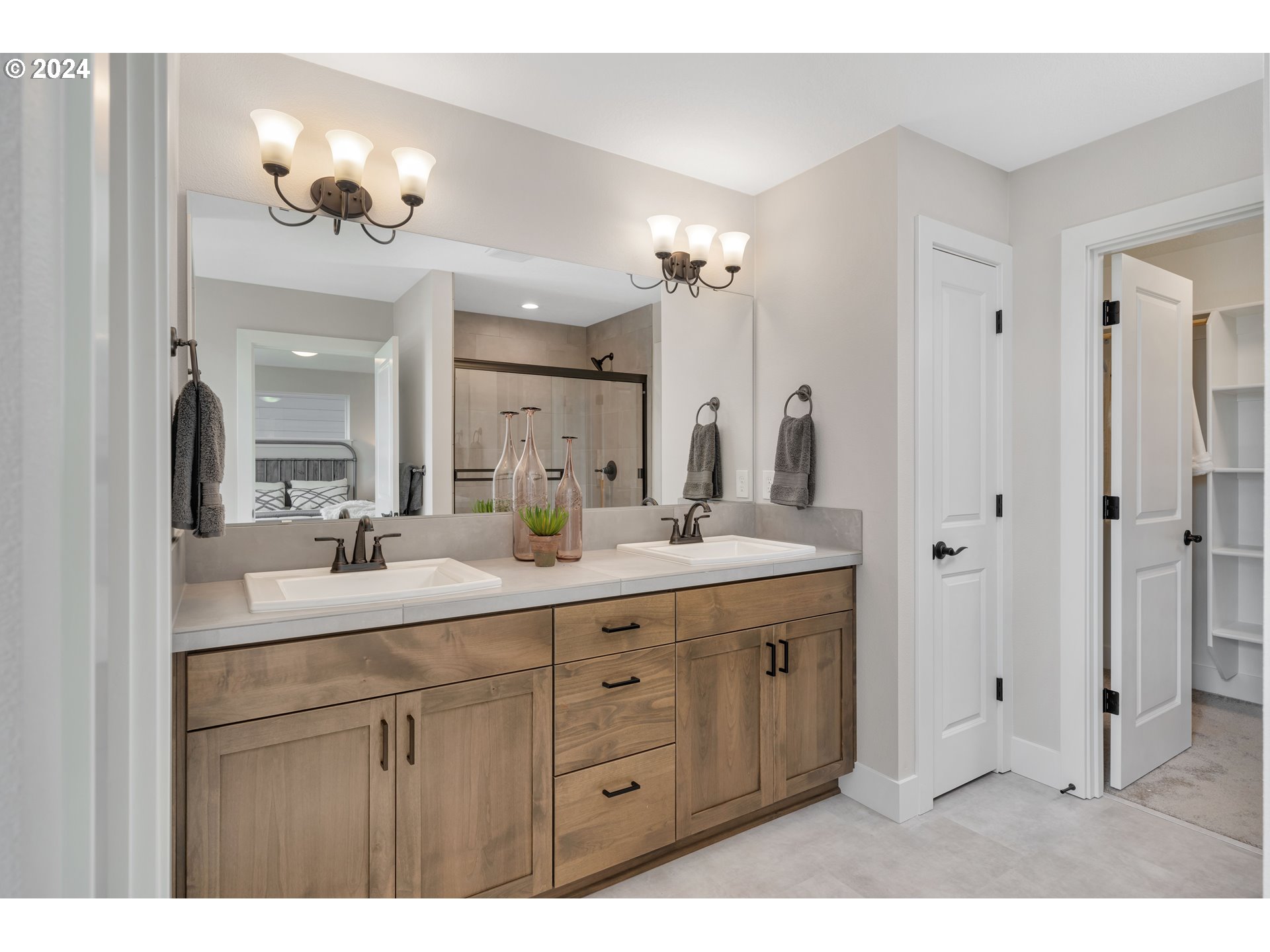 17538 Northwest 7th Avenue Ridgefield, WA 98642 - Photo 14 of 18 a bathroom with a double vanity sink a mirror and a shower