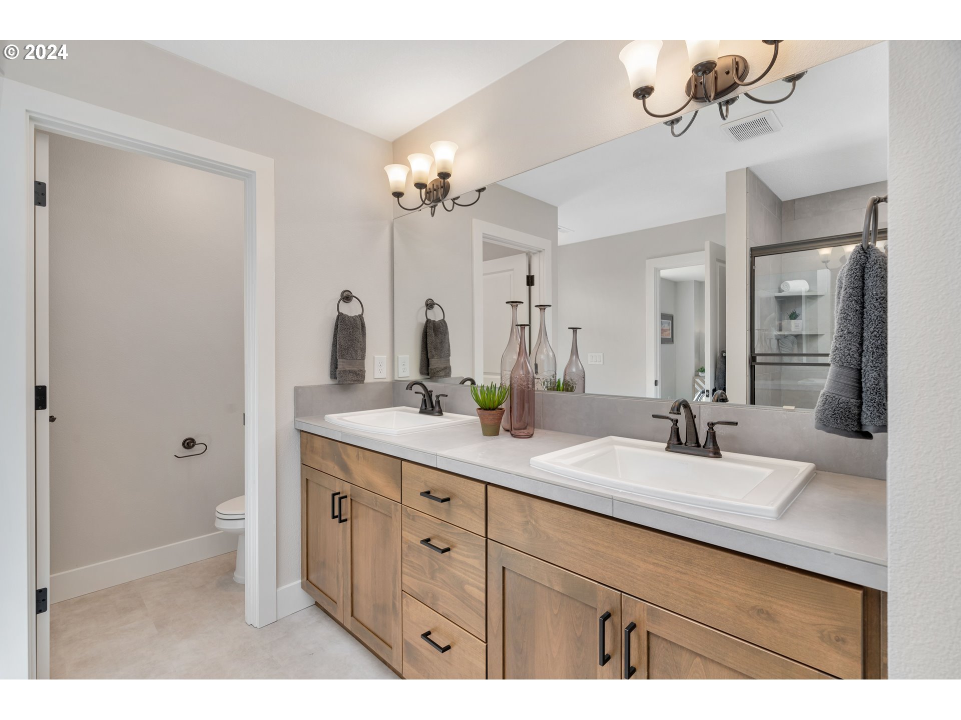 17538 Northwest 7th Avenue Ridgefield, WA 98642 - Photo 15 of 18 a bathroom with a double vanity sink a mirror a vanity and a bathtub