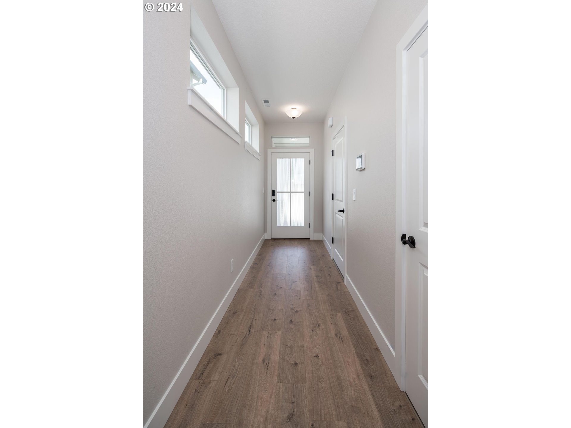 17538 Northwest 7th Avenue Ridgefield, WA 98642 - Photo 8 of 18 a view of a hallway with wooden floor