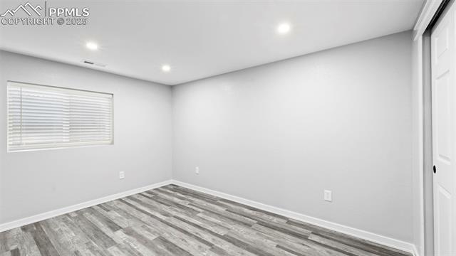 562 Blossom Field Road Fountain, CO 80817 - Photo 21 of 41 Spare room with wood finished floors and recessed lighting