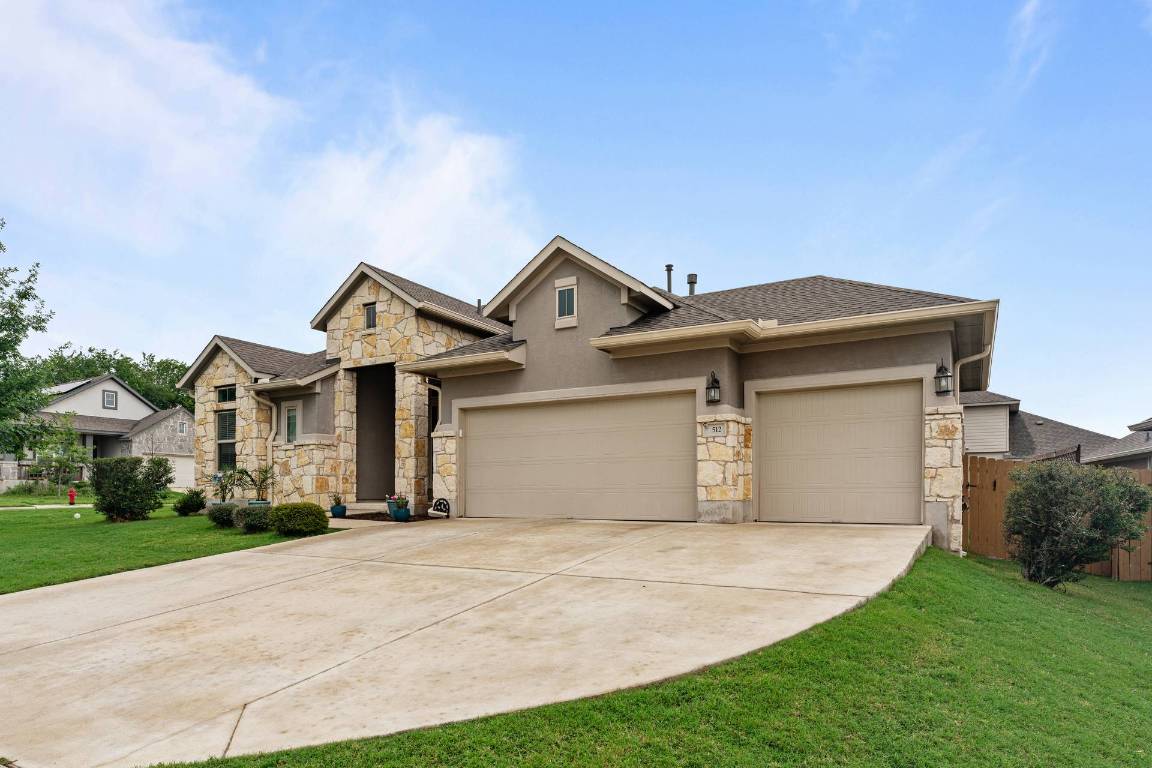 512 Bell Boot Pass Georgetown, TX 78626 - Photo 1 of 1 a front view of a house with a yard and garage