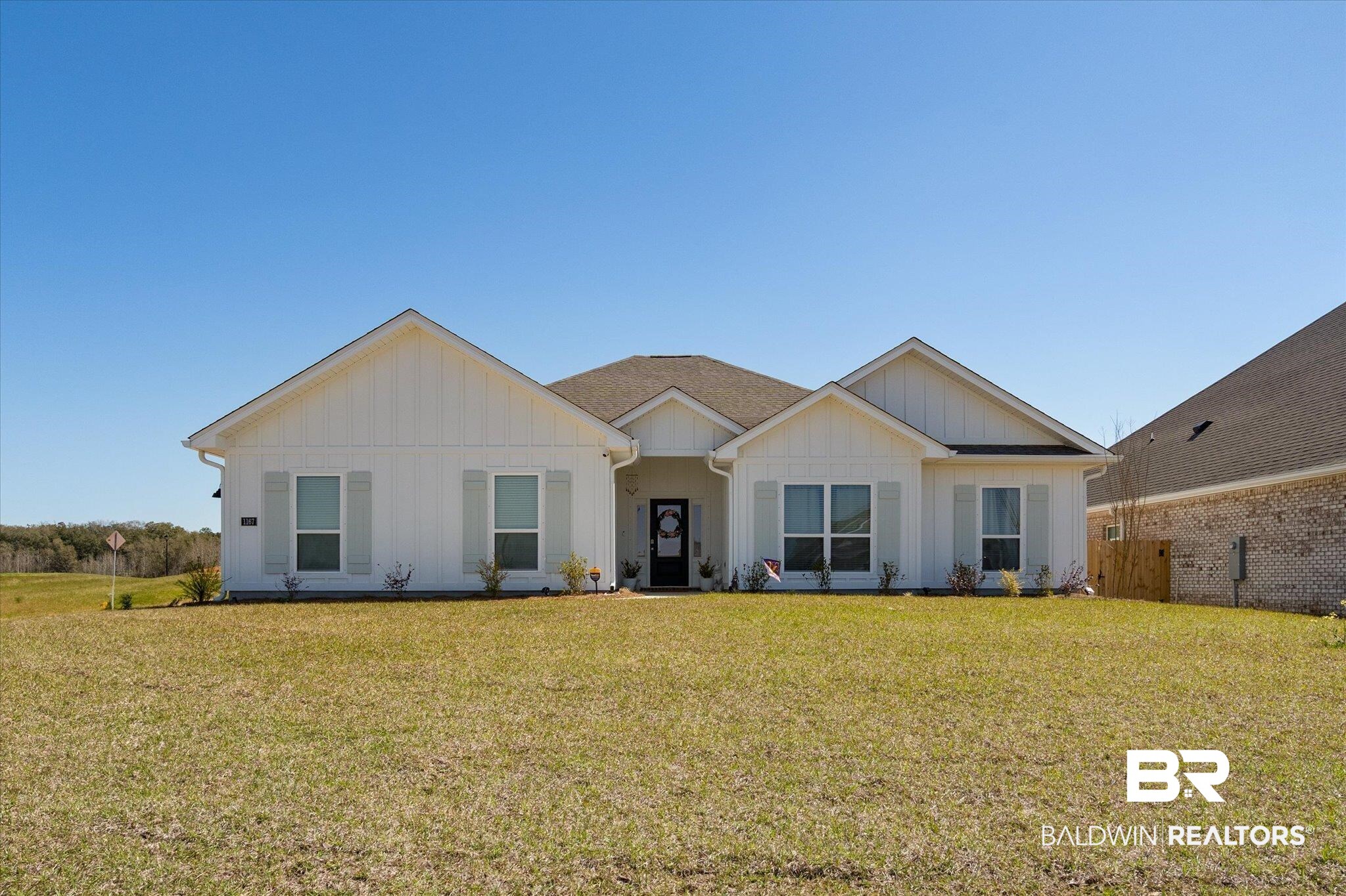 1167 Provision Road Mobile, AL 36608 - Photo 1 of 20 View of front of home featuring board and batten siding and a front yard