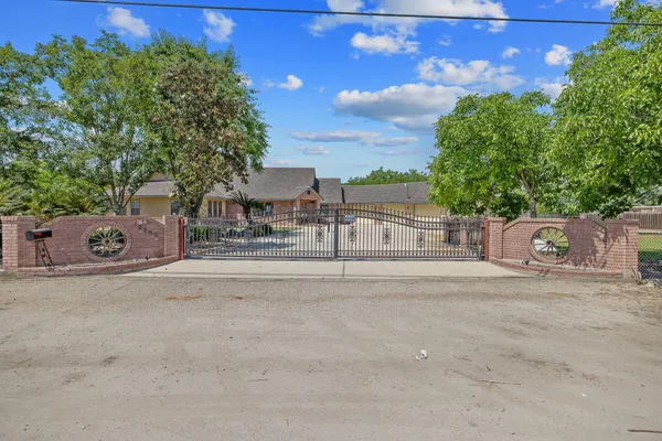 a front view of a house with a yard and outdoor seating