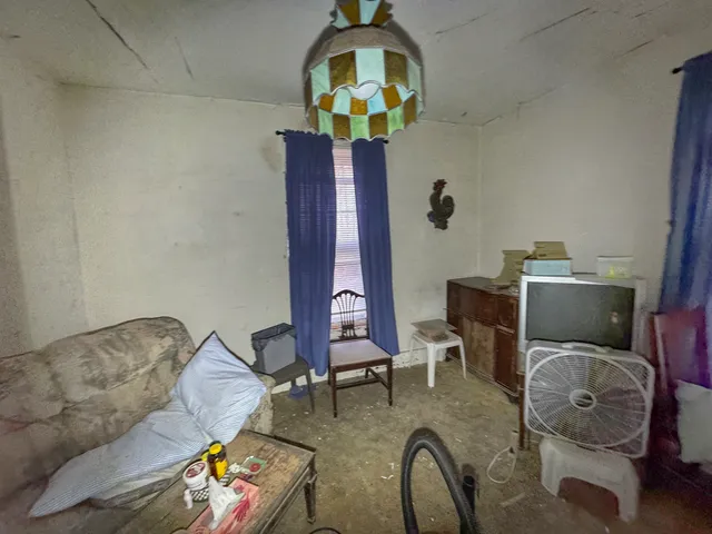 a living room with furniture and floor to ceiling window