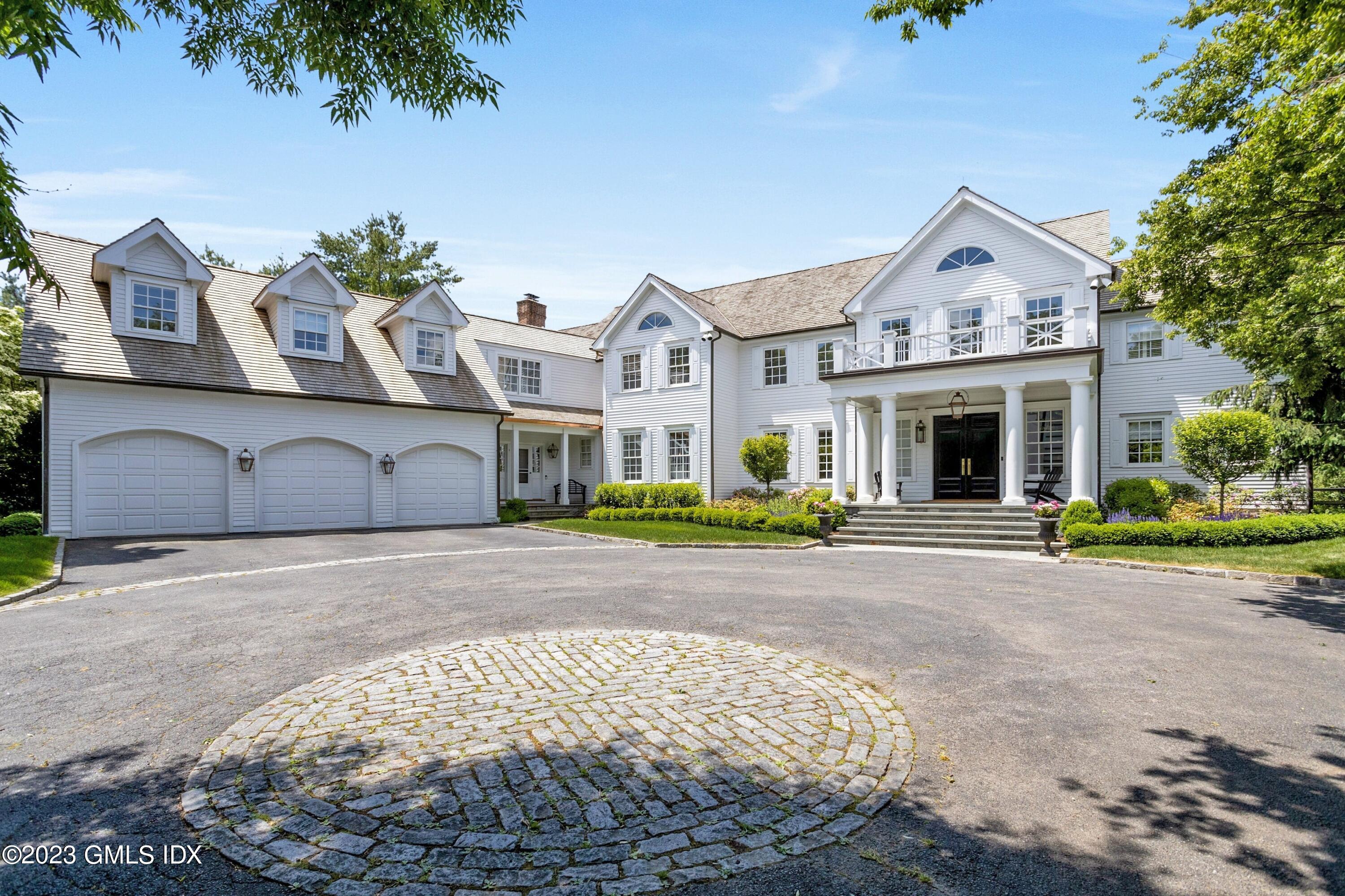 400 Stanwich Road Greenwich, CT 06830 - Photo 2 of 37 a front view of a house with a yard and garage