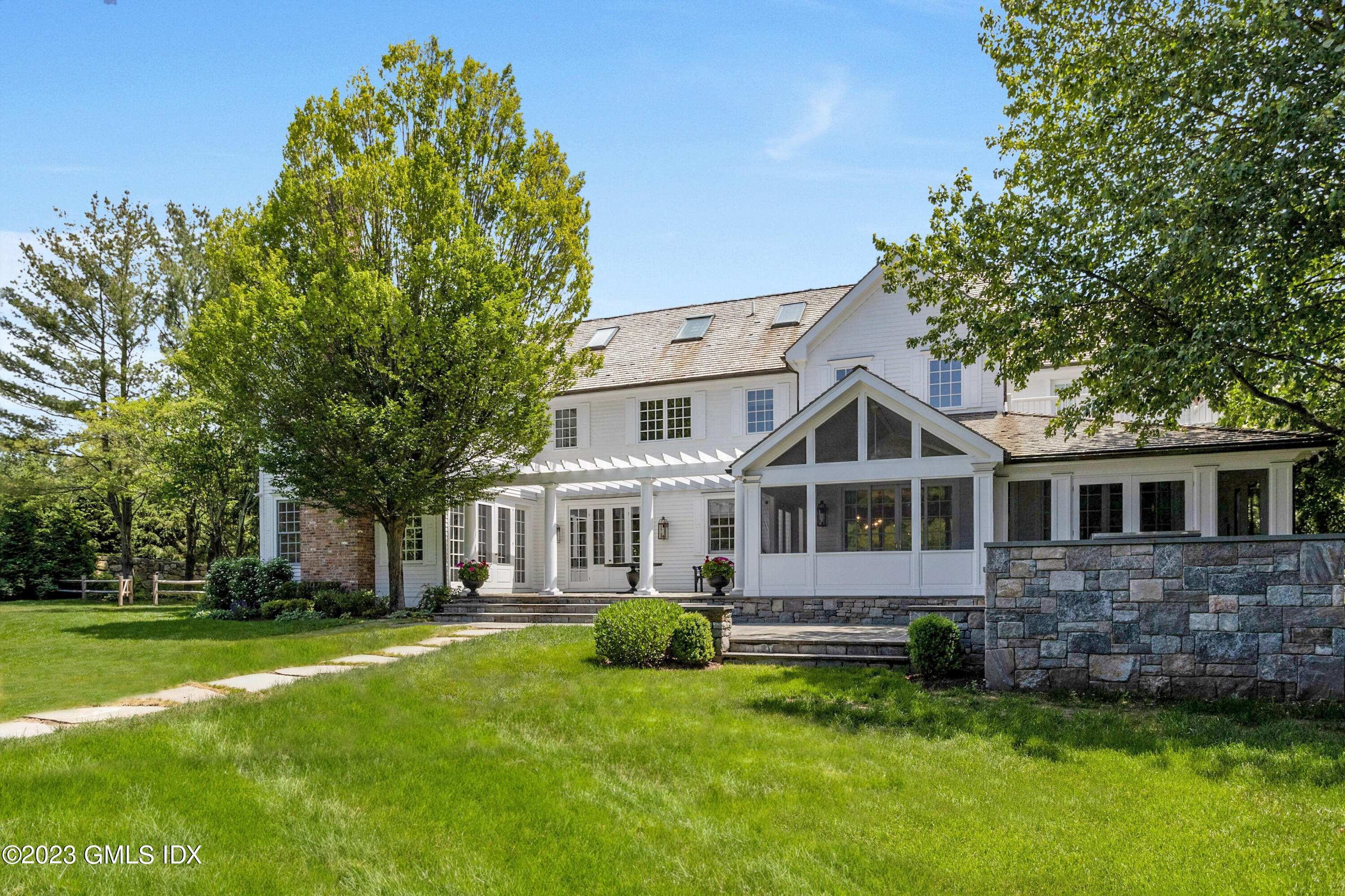 400 Stanwich Road Greenwich, CT 06830 - Photo 23 of 37 a front view of a house with a yard