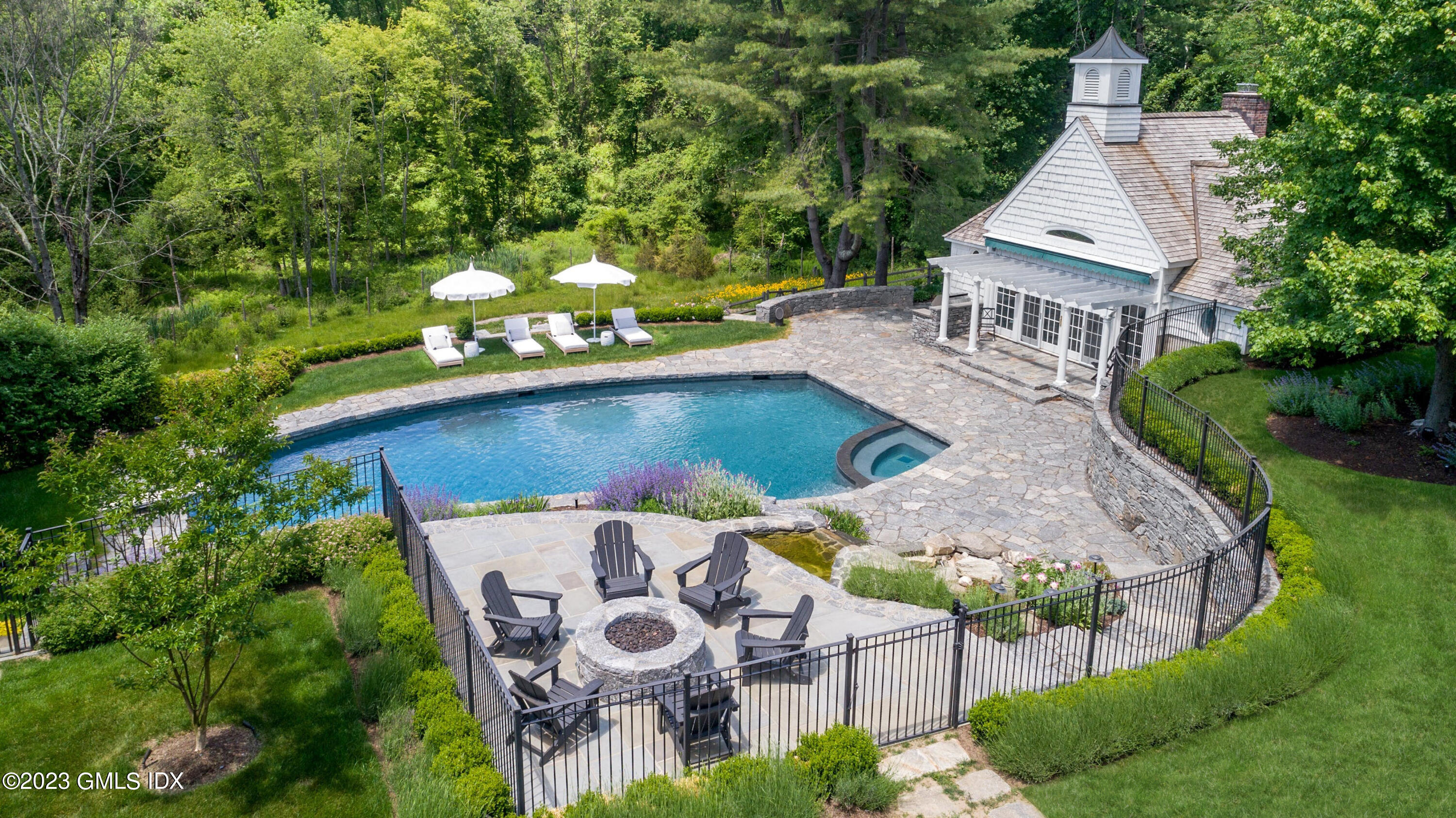 400 Stanwich Road Greenwich, CT 06830 - Photo 24 of 37 an aerial view of a house with yard swimming pool and outdoor seating