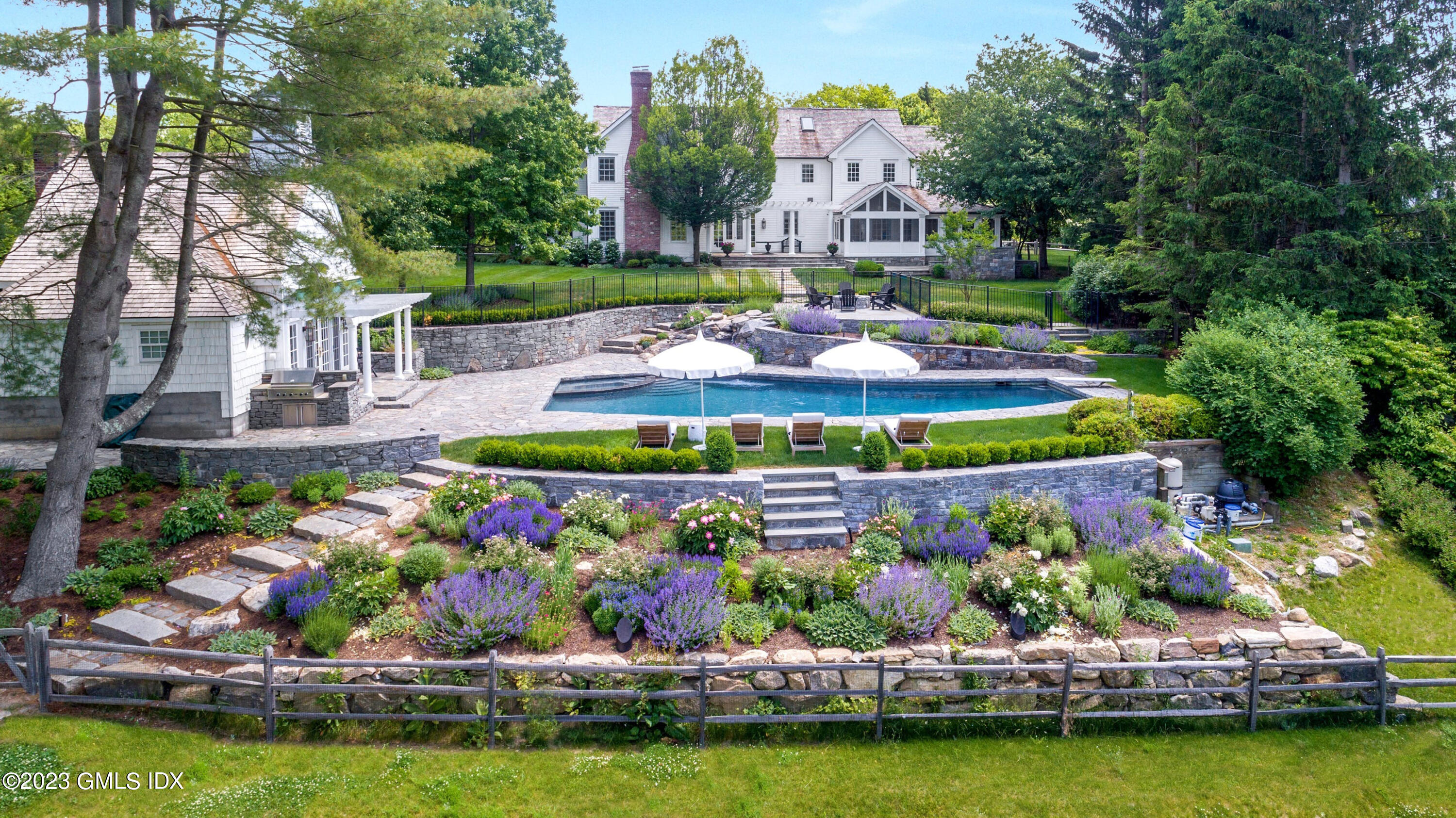 400 Stanwich Road Greenwich, CT 06830 - Photo 25 of 37 a view of a swimming pool with lawn chairs and plants