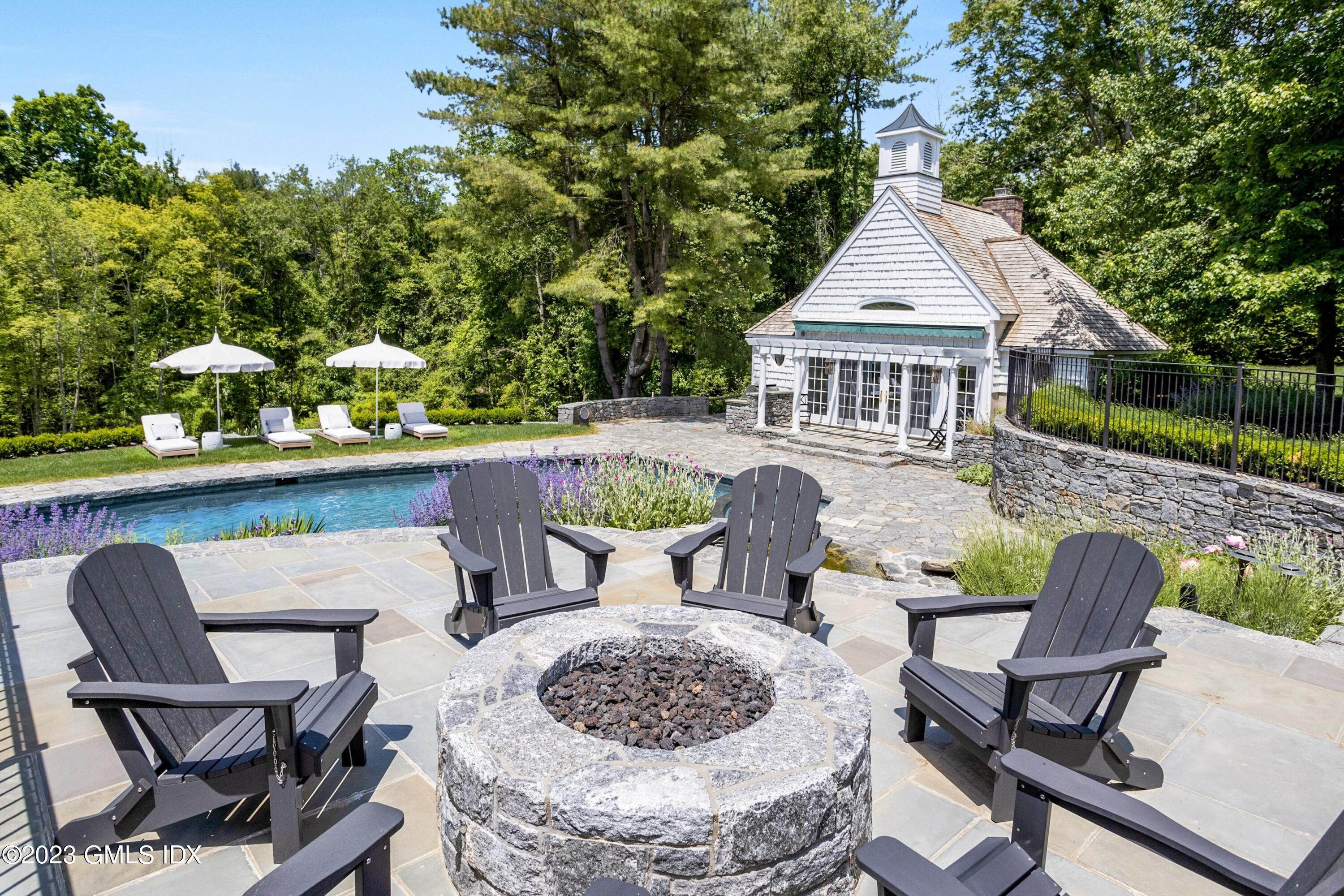 400 Stanwich Road Greenwich, CT 06830 - Photo 28 of 37 a view of a patio with table and chairs and potted plants with wooden floor and fence