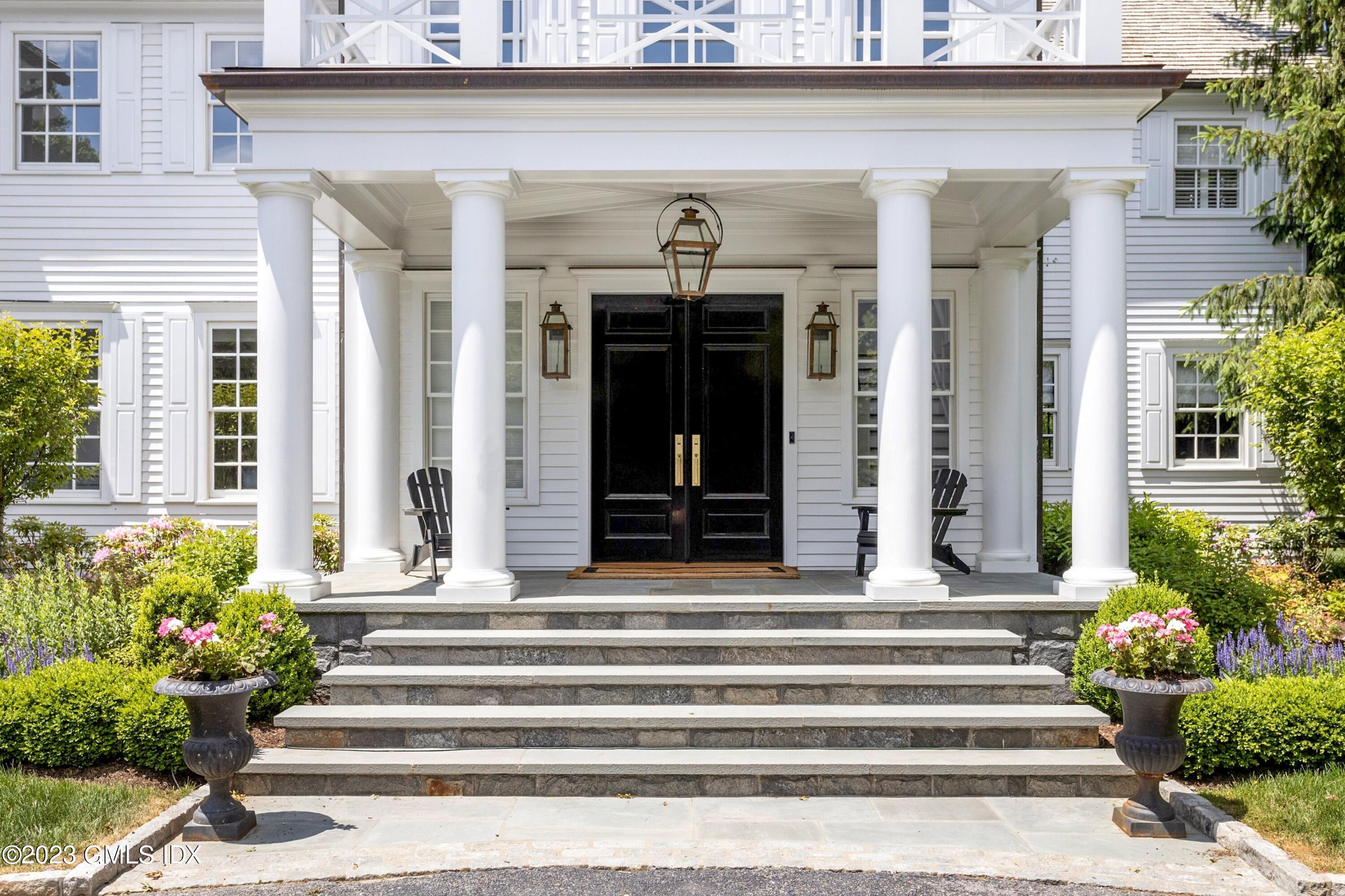 400 Stanwich Road Greenwich, CT 06830 - Photo 3 of 37 a front view of a house with potted plants