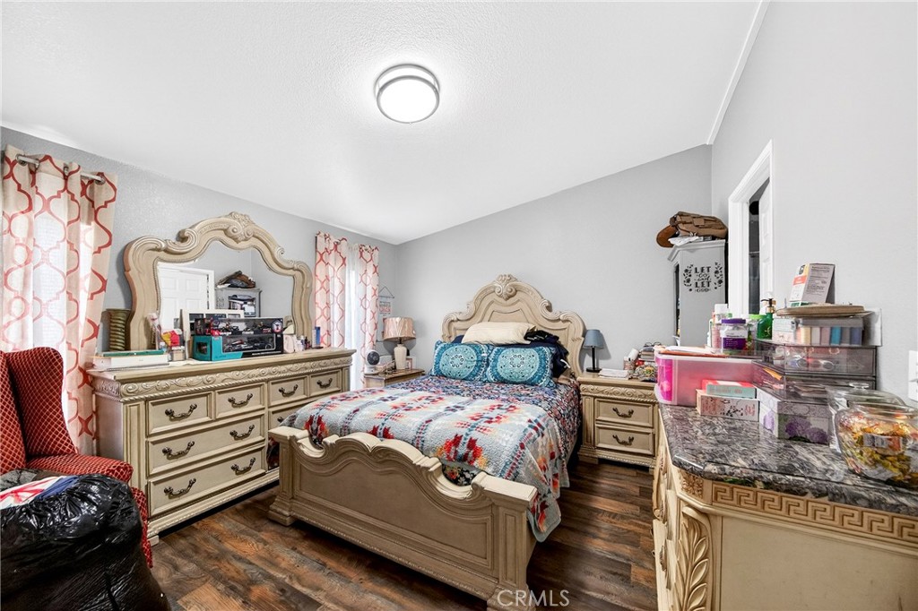 1241 North East Street Anaheim, CA 92805 - Photo 6 of 8 a bedroom with furniture and a chandelier