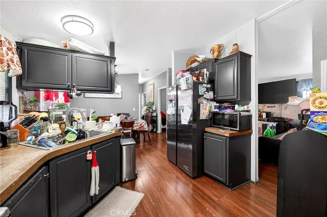 a kitchen filled with stainless steel appliances a stove top oven and a refrigerator