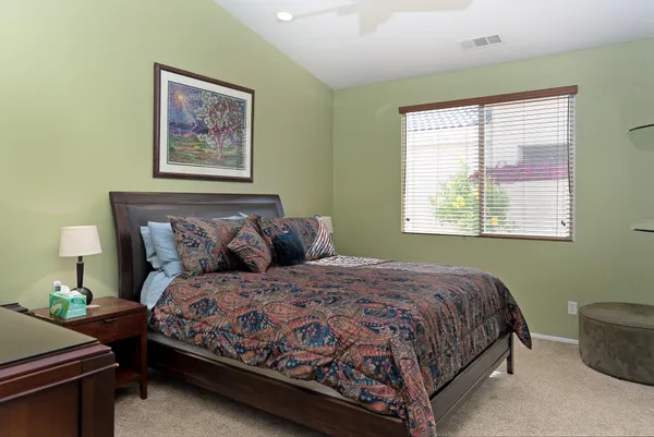 a bedroom with bed and a window