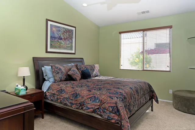 a bedroom with bed and a window