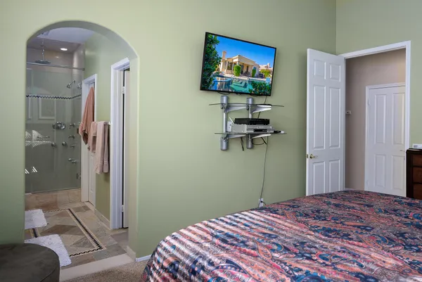 a bedroom with a bed and a chandelier