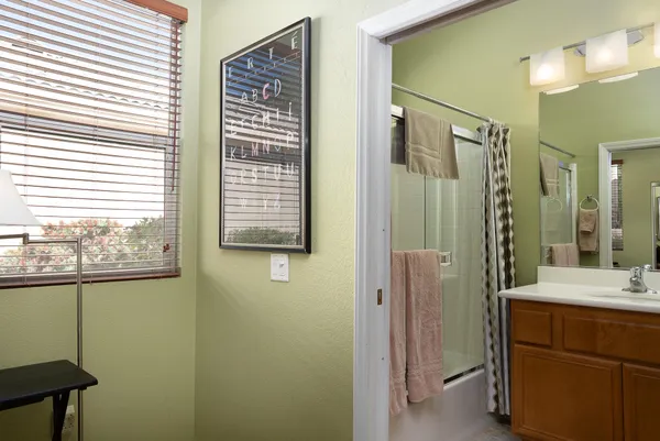 a bathroom with a sink vanity and a mirror