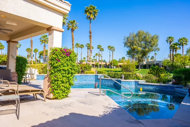 a view of a chairs and table in a backyard