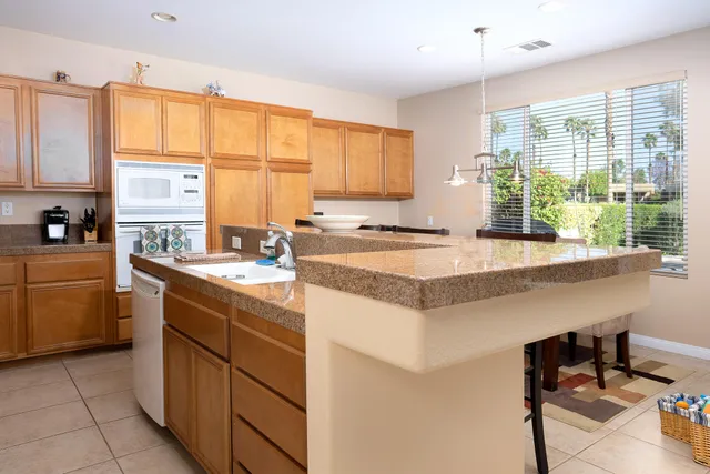 a kitchen with a stove a sink a refrigerator and a window