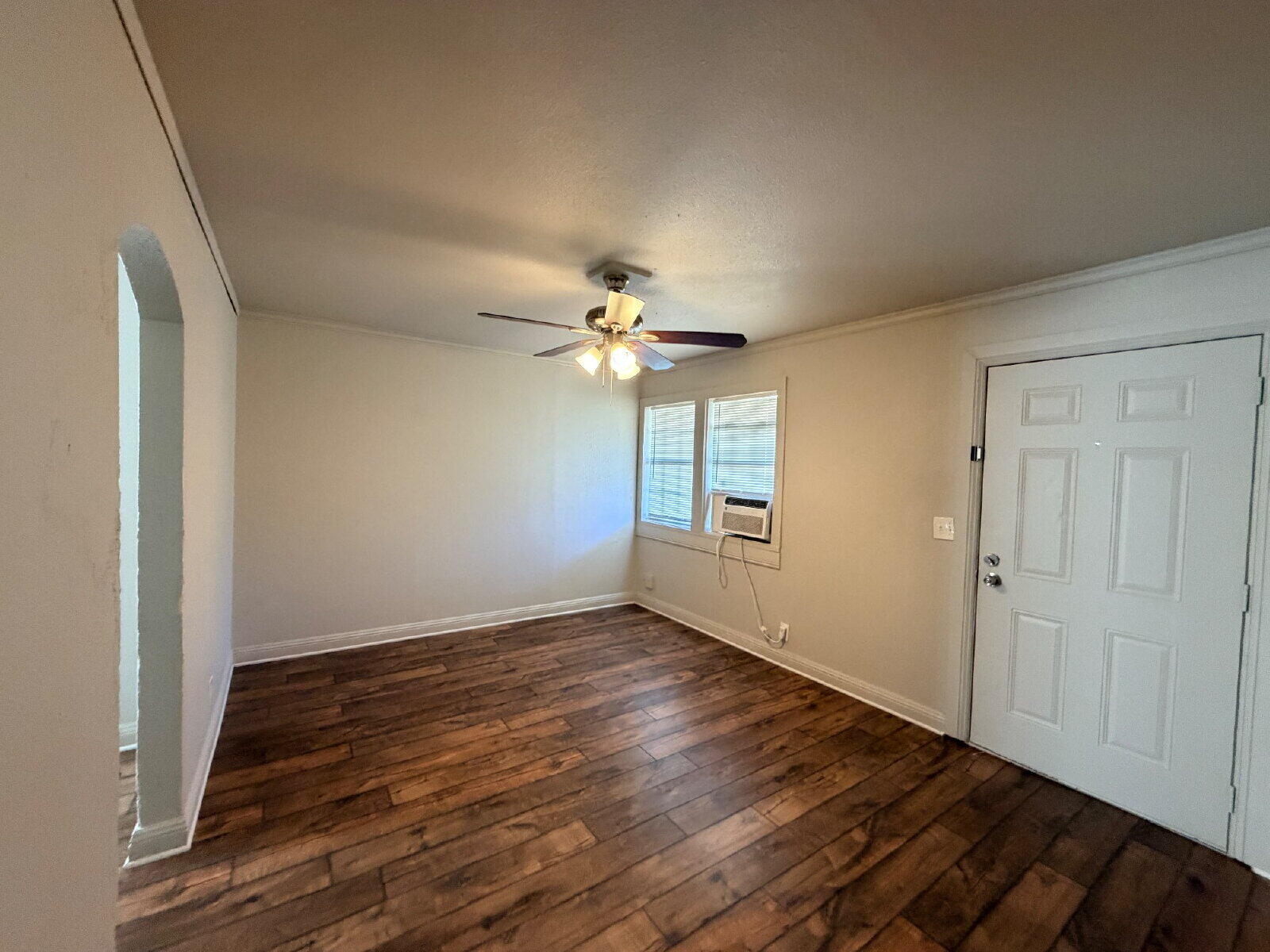 4923 35th Street Lubbock, TX 79414 - Photo 4 of 10 a view of an empty room with wooden floor