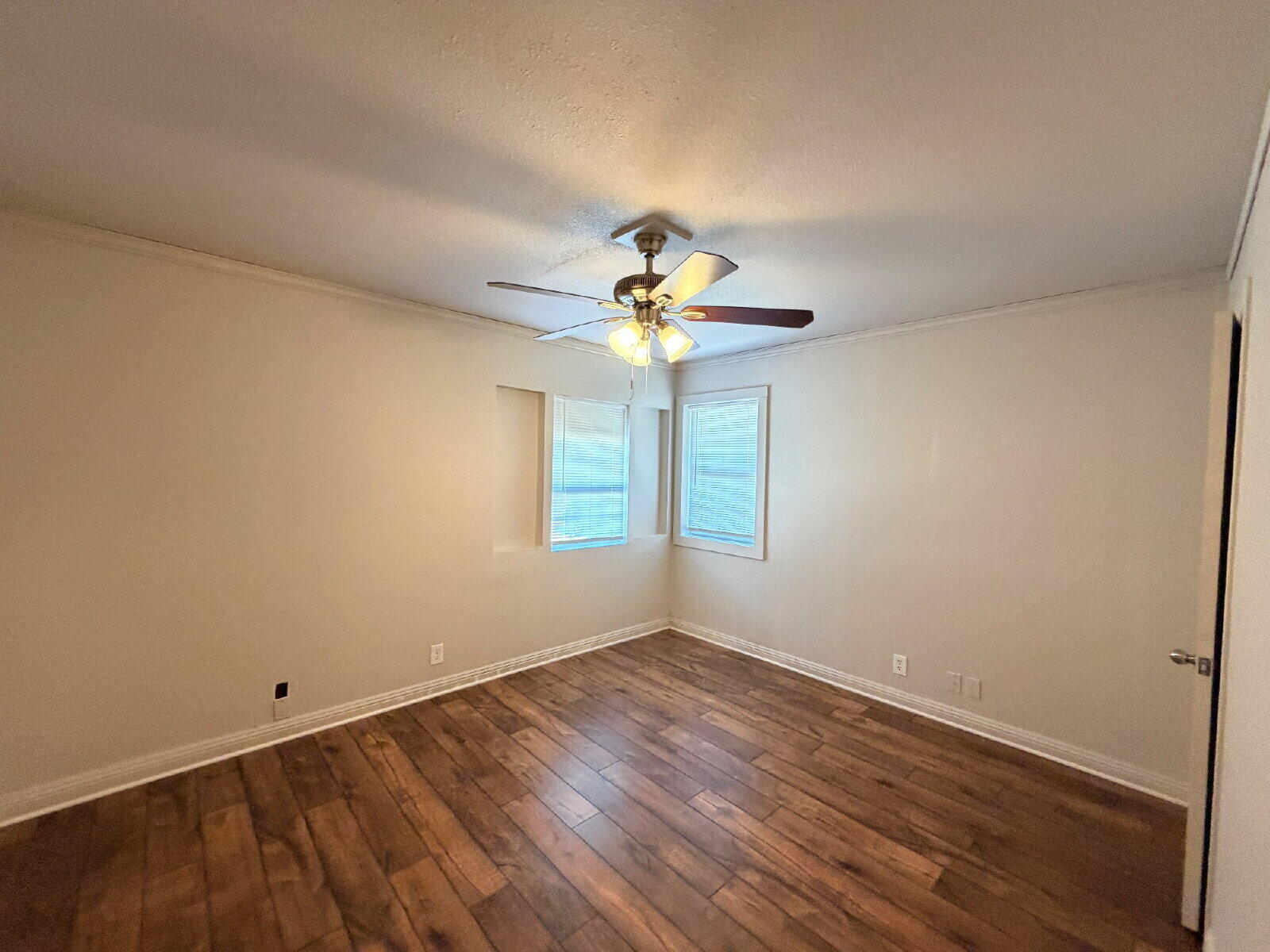 4923 35th Street Lubbock, TX 79414 - Photo 6 of 10 a view of wooden floor and chandelier fan in a room