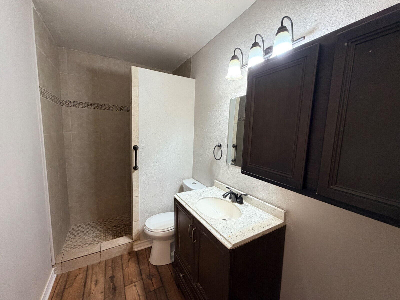 4923 35th Street Lubbock, TX 79414 - Photo 7 of 10 a bathroom with a sink a toilet and shower