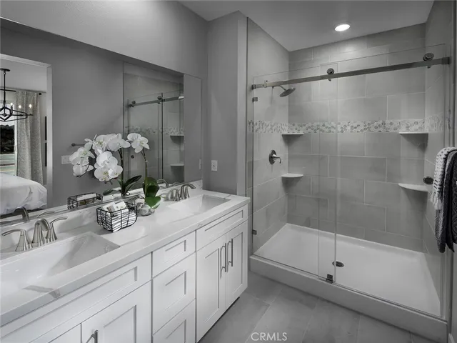 a bathroom with a shower sink and mirror