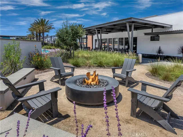 a view of a patio with couches table and chairs and potted plants