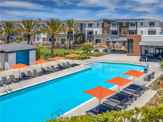 swimming pool with outdoor seating and lots of buildings