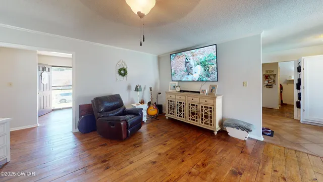a living room with furniture and wooden floor