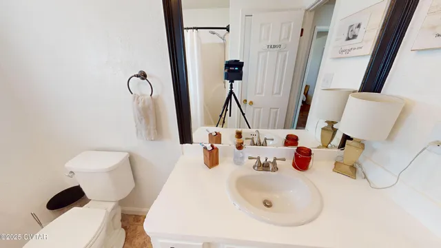 a living room with a flat screen tv a bed and a flat screen tv