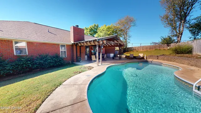 a view of a house with pool porch and chairs