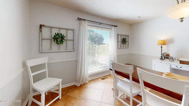 a view of a hallway with workspace and a window