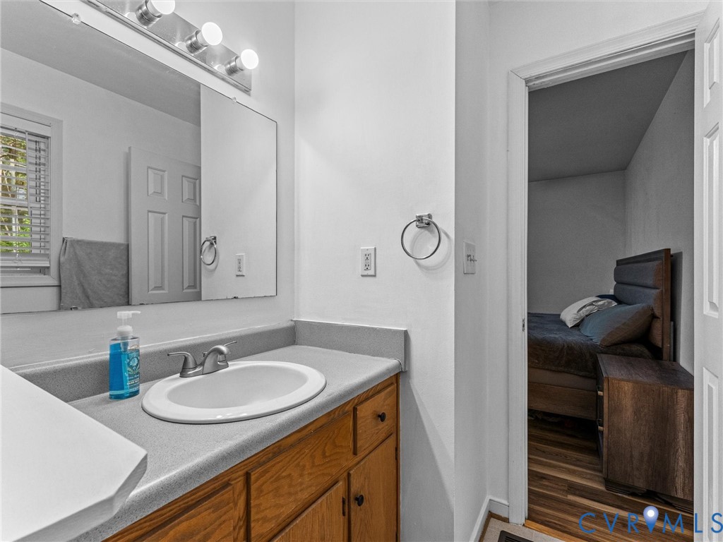 14175 Lebanon Road Disputanta, VA 23842 - Photo 28 of 60 Owner's Bathroom vanity featuring wood-finish cabi