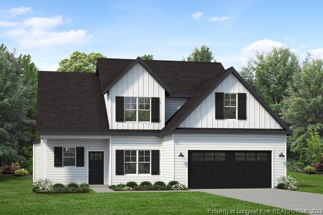 a front view of a house with a garden and yard