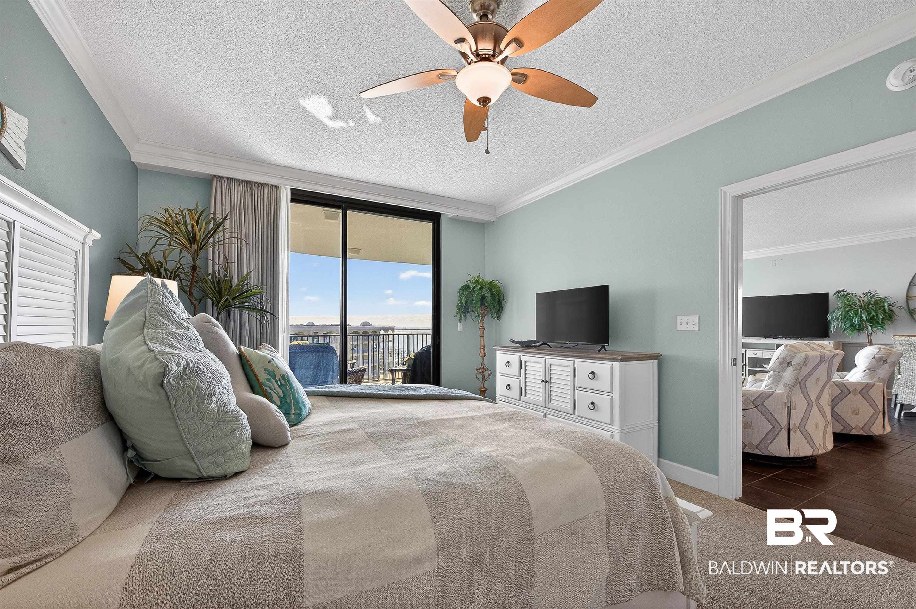 27582 Canal Road, Unit 2507 Orange Beach, AL 36561 - Photo 29 of 75 Bedroom with a textured ceiling, access to exterior, ornamental molding, carpet floors, and a ceiling fan