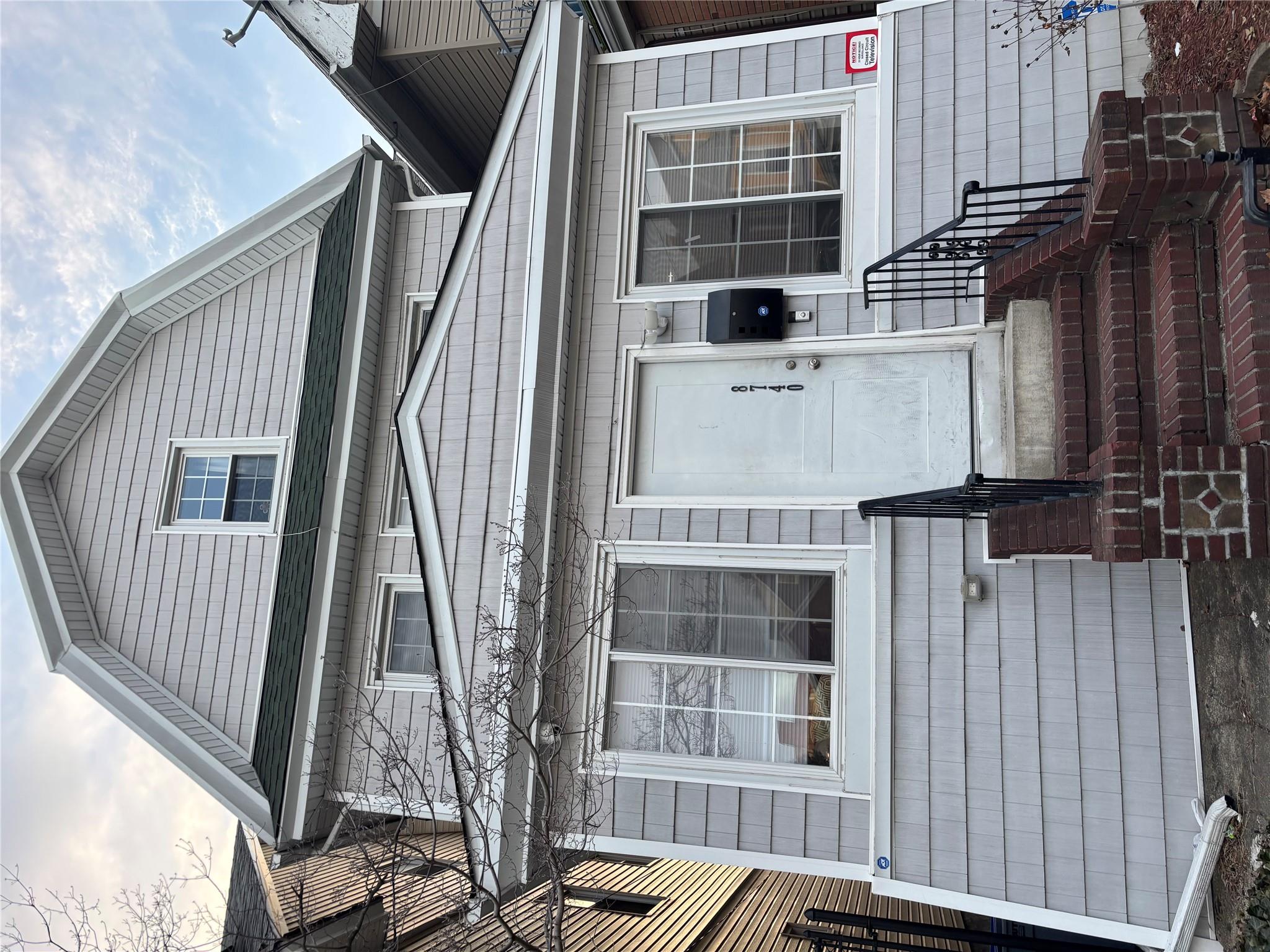 View of front of property with entry steps and a gambrel roof