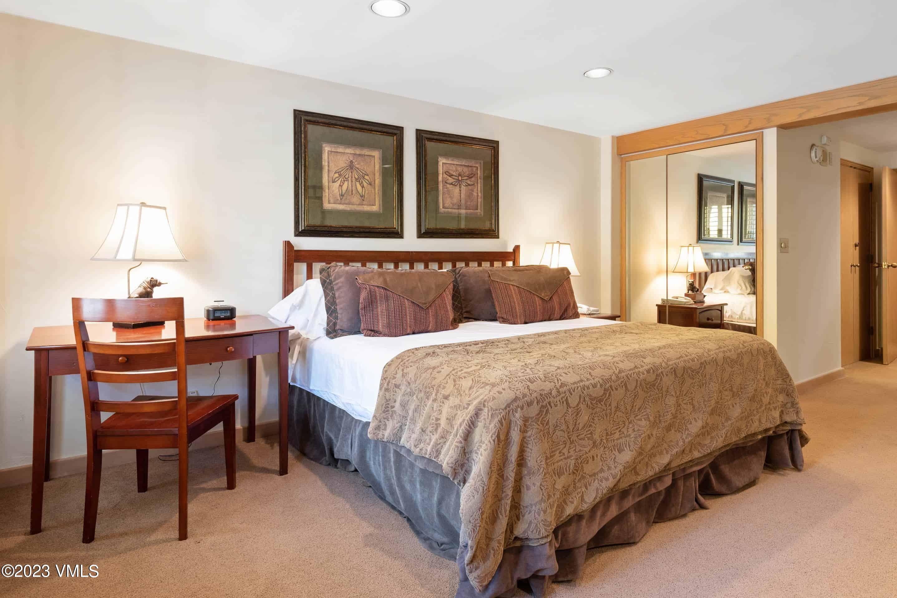 200 Vail Road, Unit 287 Vail, CO 81657 - Photo 12 of 21 a bed room with a bed and a table