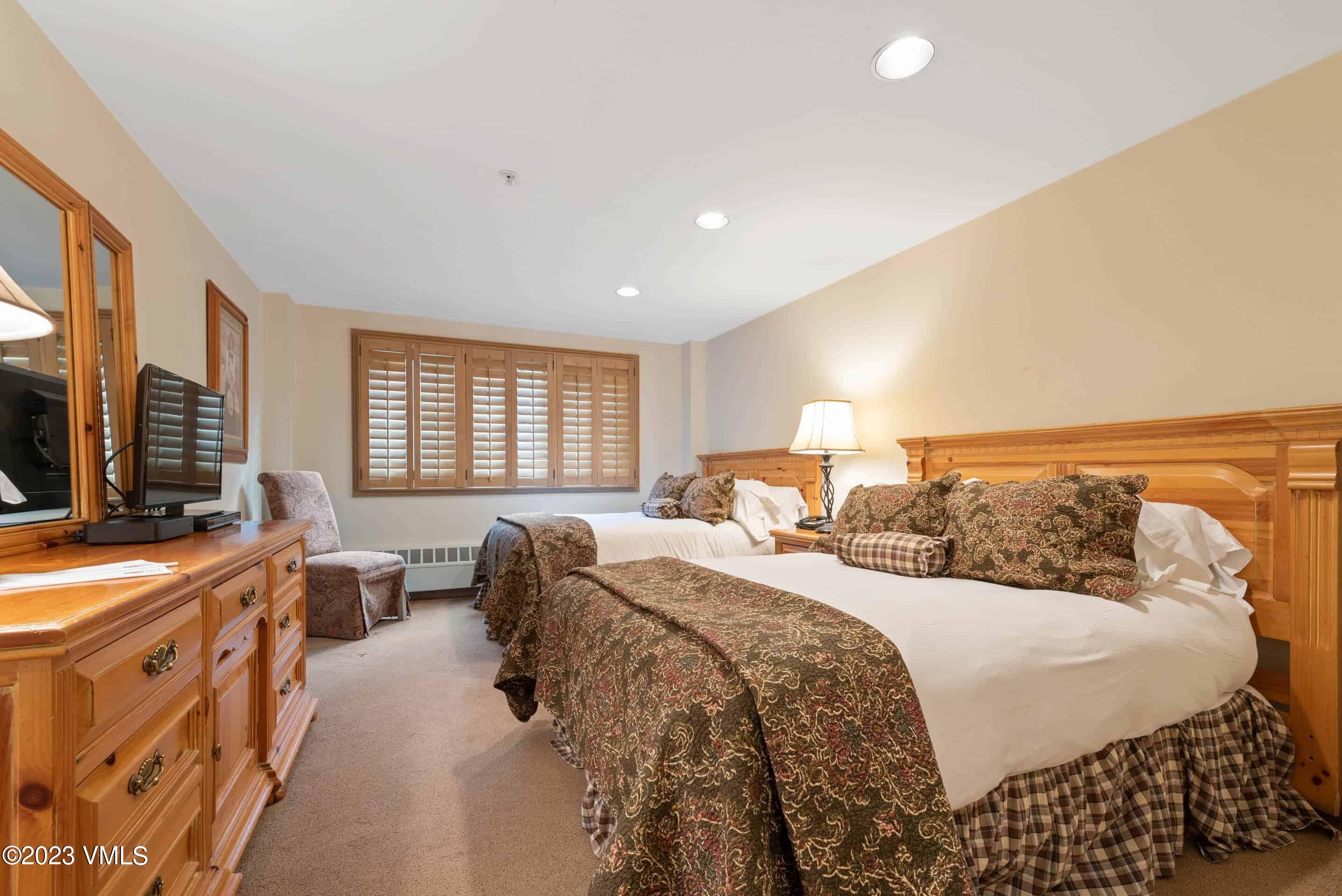 200 Vail Road, Unit 287 Vail, CO 81657 - Photo 15 of 21 a bed room with a bed and a television